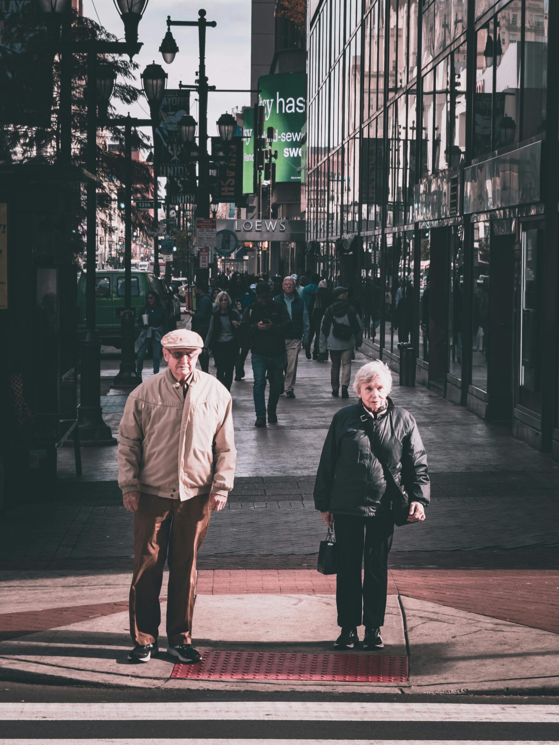 Picture of an older couple crossing the streets. Puprose of the image is to illustrate the writing exercise love in difficult times.